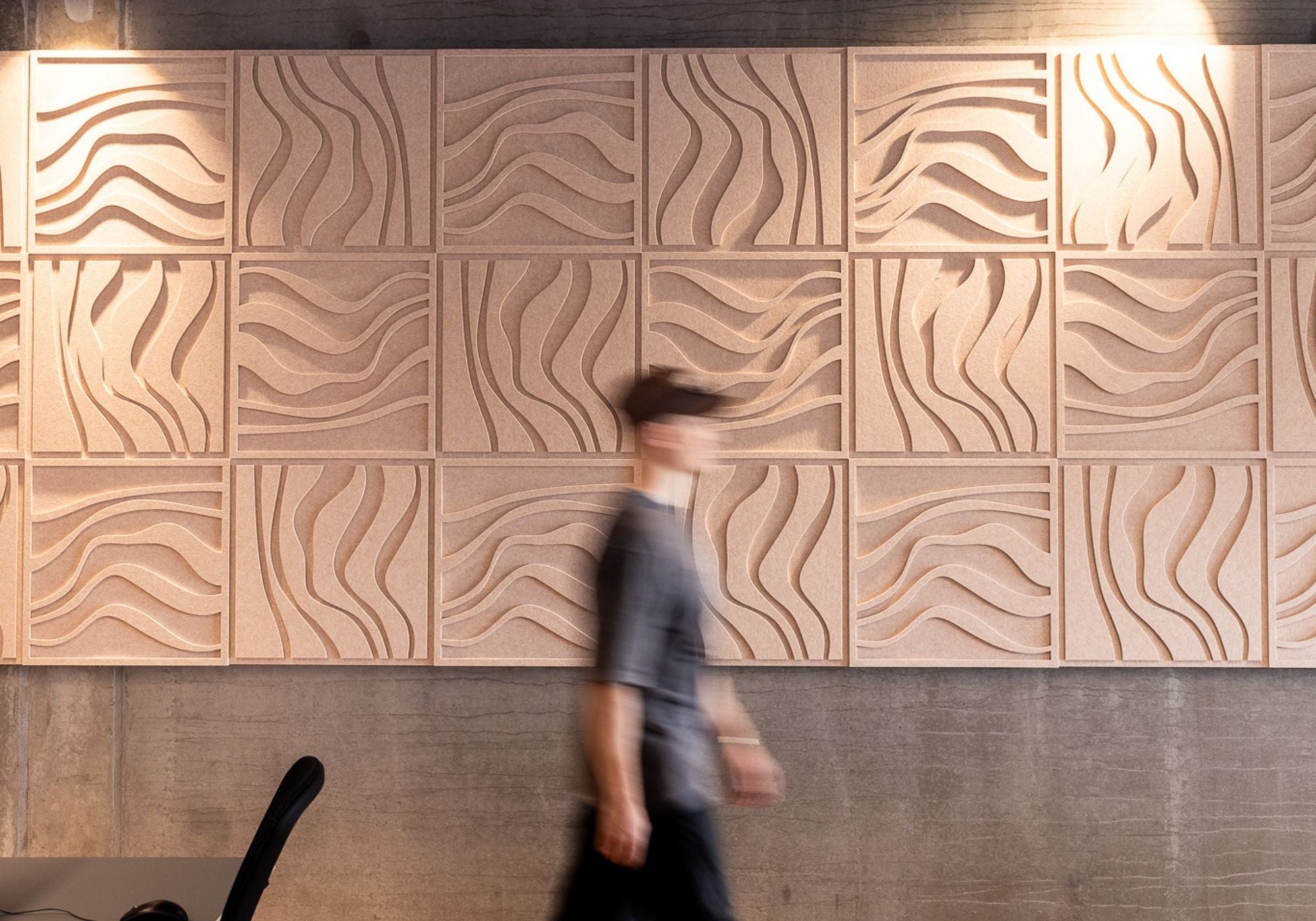 Large-scale decorative soundproofing panels with sculptural wave patterns, offering acoustic control and modern design inspiration.